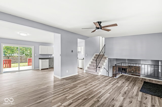 unfurnished living room featuring light hardwood / wood-style flooring and ceiling fan