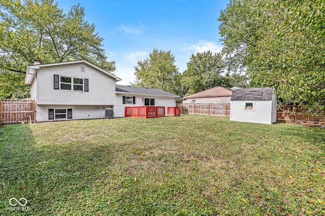 view of yard with cooling unit, a storage shed, and a wooden deck