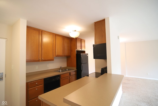 kitchen featuring carpet, black appliances, and sink