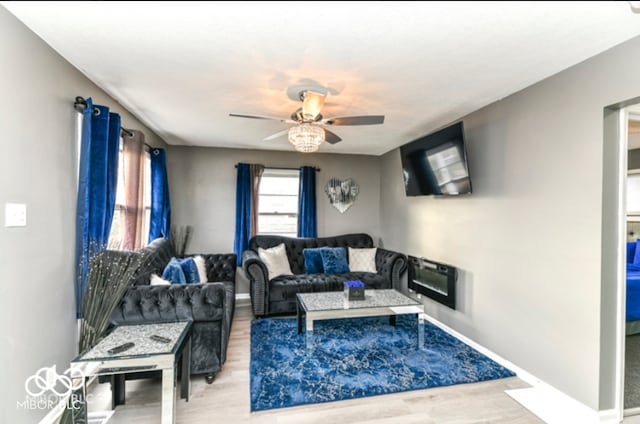 living room with ceiling fan and hardwood / wood-style flooring