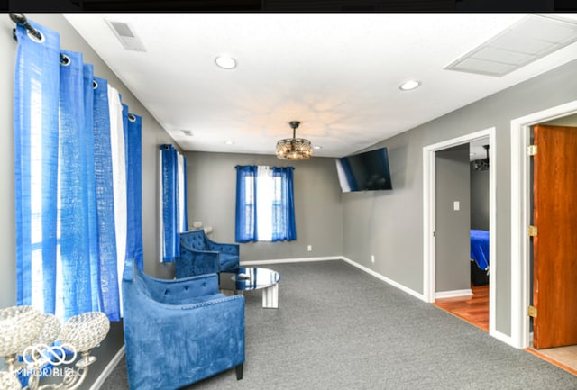 living area with carpet floors and a chandelier