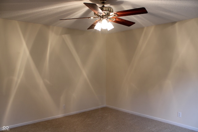 unfurnished room featuring a textured ceiling, carpet floors, and ceiling fan