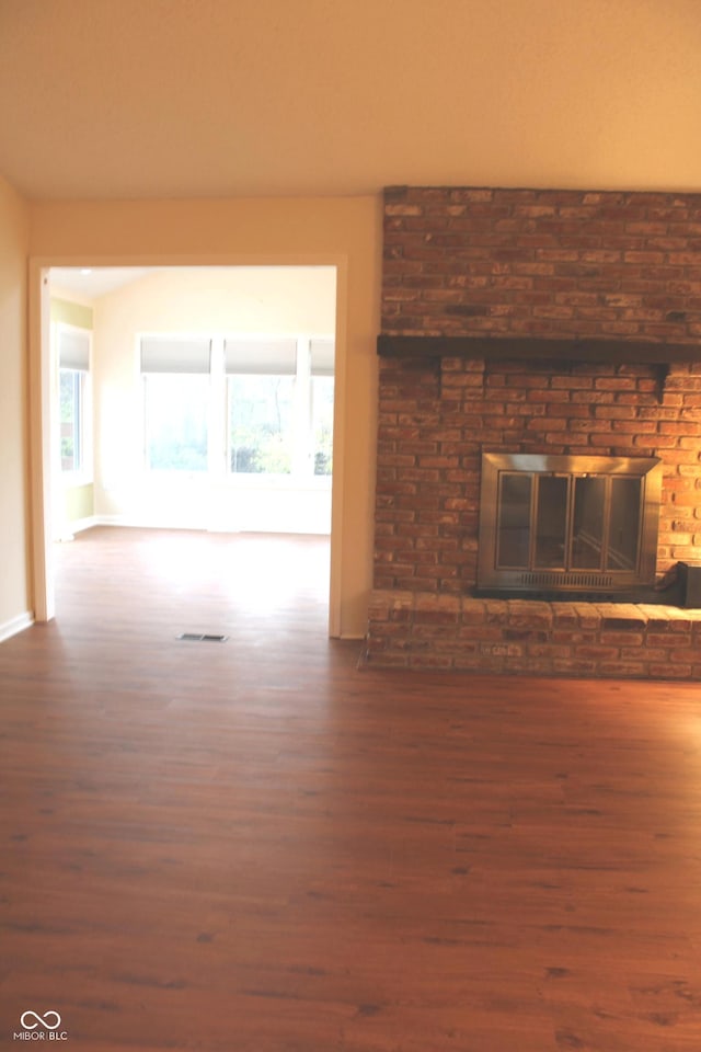 unfurnished living room with dark hardwood / wood-style floors and a fireplace