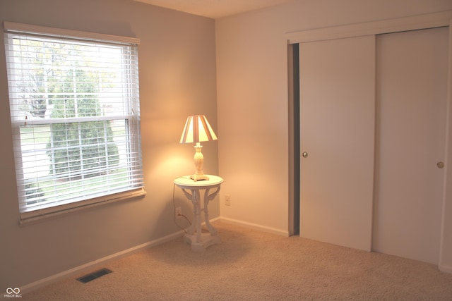 unfurnished bedroom featuring carpet and a closet