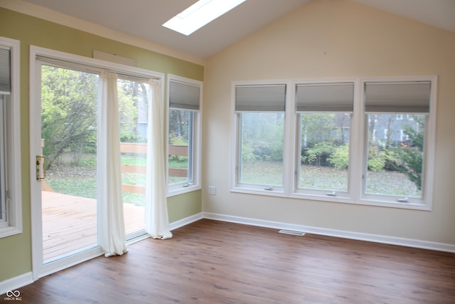 unfurnished sunroom featuring lofted ceiling with skylight