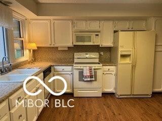 kitchen with sink, white cabinets, dark hardwood / wood-style flooring, backsplash, and white appliances