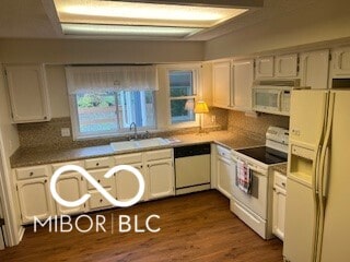 kitchen with dark hardwood / wood-style floors, white cabinetry, sink, backsplash, and white appliances