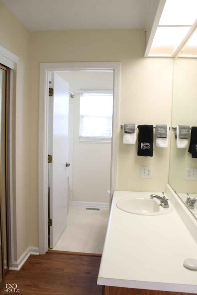 bathroom featuring vanity and hardwood / wood-style floors