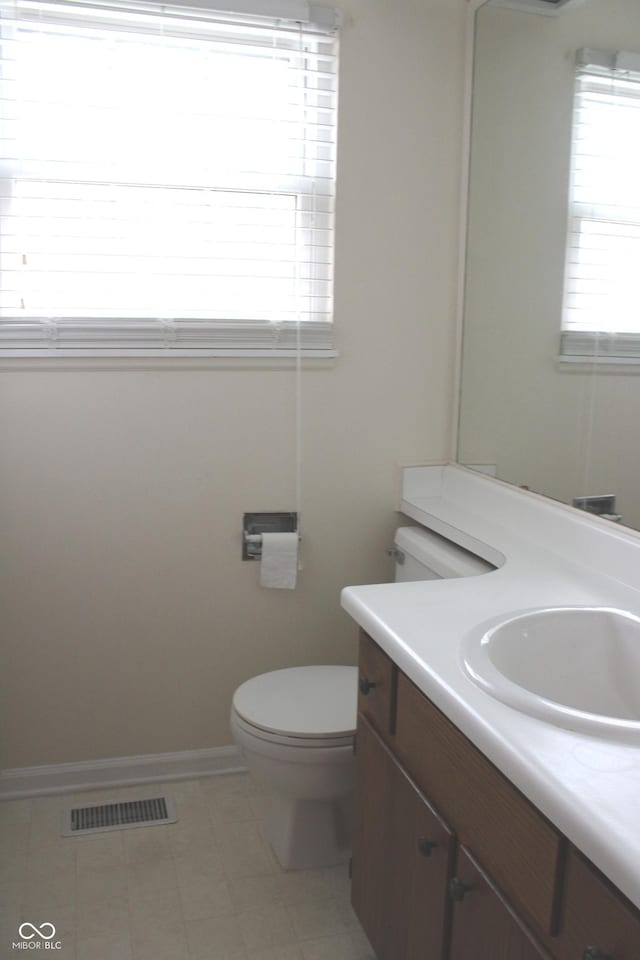 bathroom featuring tile patterned flooring, vanity, and toilet