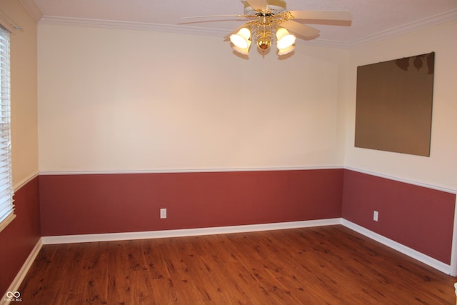 empty room featuring dark hardwood / wood-style flooring, ornamental molding, and a healthy amount of sunlight