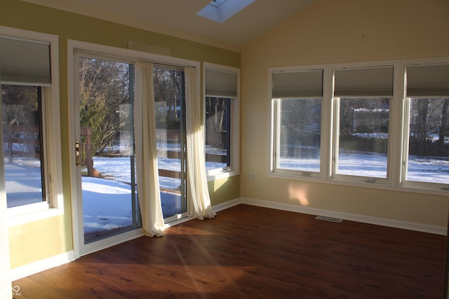 unfurnished sunroom featuring lofted ceiling with skylight