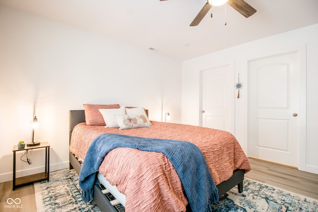 bedroom with light hardwood / wood-style floors and ceiling fan