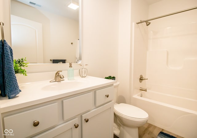 full bathroom featuring vanity, toilet, and bathtub / shower combination