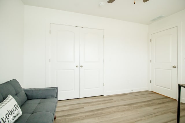 sitting room with ceiling fan and light hardwood / wood-style floors