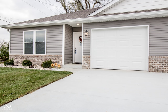 view of front of house with a front yard and a garage