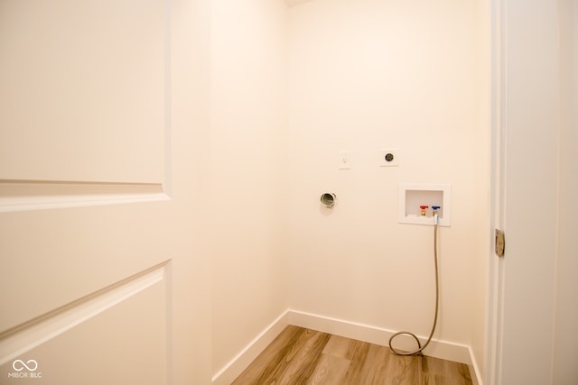 washroom with electric dryer hookup, washer hookup, and light wood-type flooring