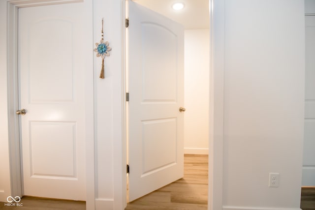 hallway with light hardwood / wood-style floors