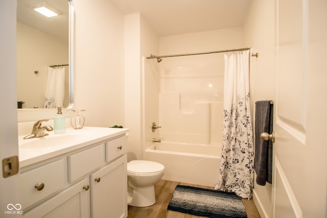 full bathroom with hardwood / wood-style floors, vanity, toilet, and shower / bath combination with curtain