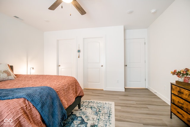 bedroom with ceiling fan and wood-type flooring