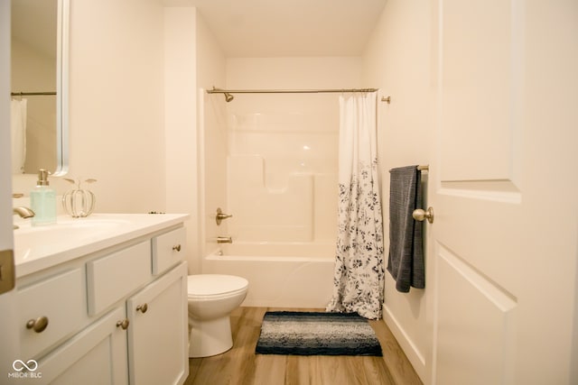 full bathroom featuring vanity, toilet, wood-type flooring, and shower / bath combo