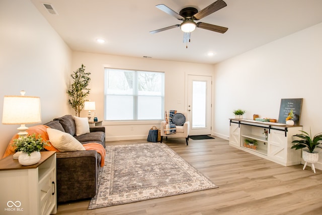 sitting room with ceiling fan and light hardwood / wood-style floors