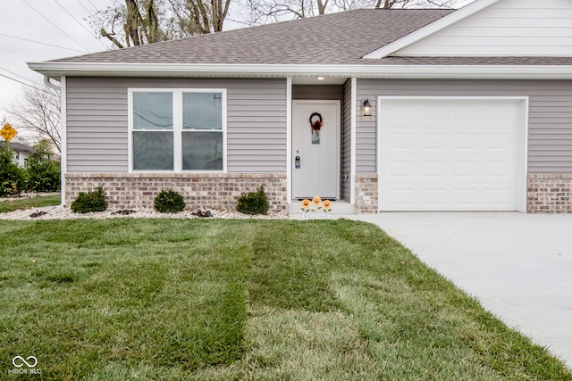 view of front facade with a front yard and a garage