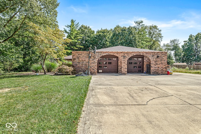 exterior space with a garage and a front lawn