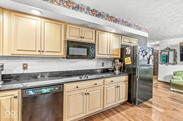 kitchen with dark stone counters, light hardwood / wood-style floors, a textured ceiling, black appliances, and light brown cabinets