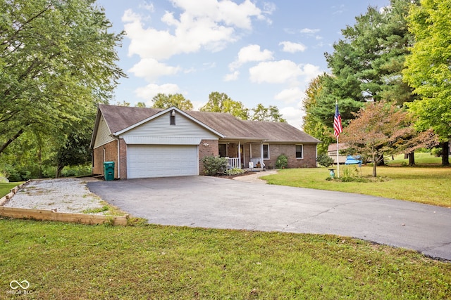 single story home with a garage, a front lawn, and covered porch