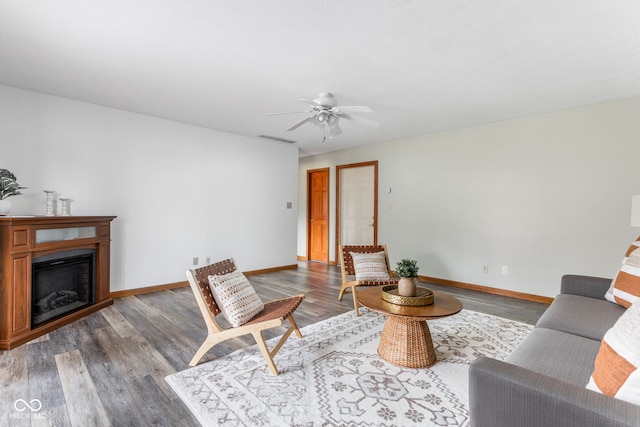 living room featuring hardwood / wood-style flooring and ceiling fan