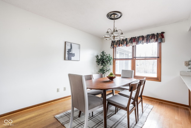 dining room with a notable chandelier and light hardwood / wood-style floors