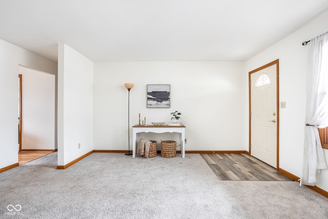 view of carpeted foyer entrance