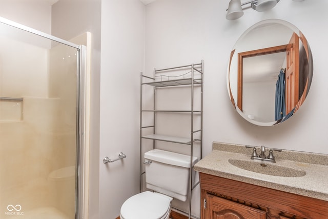 bathroom with walk in shower, vanity, and toilet