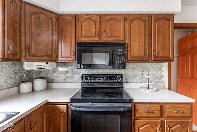 kitchen with backsplash and black appliances