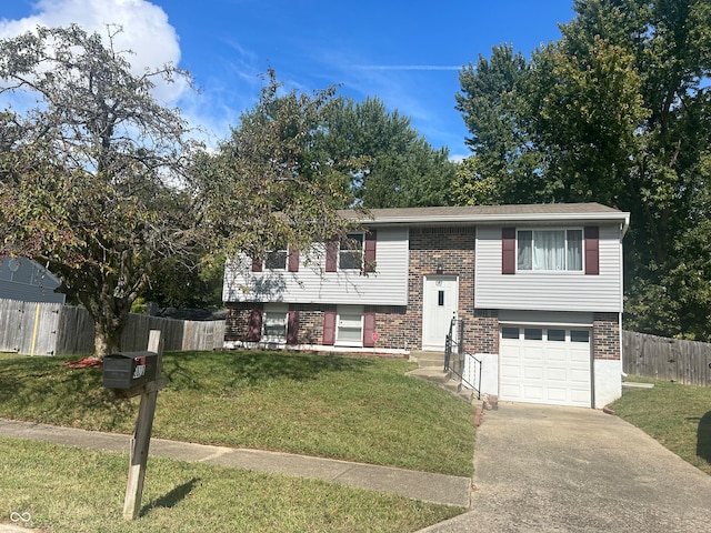 bi-level home with a front yard and a garage