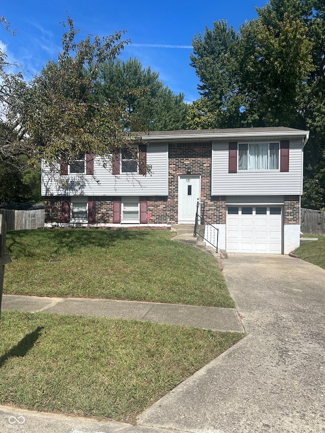 split foyer home with a front yard and a garage