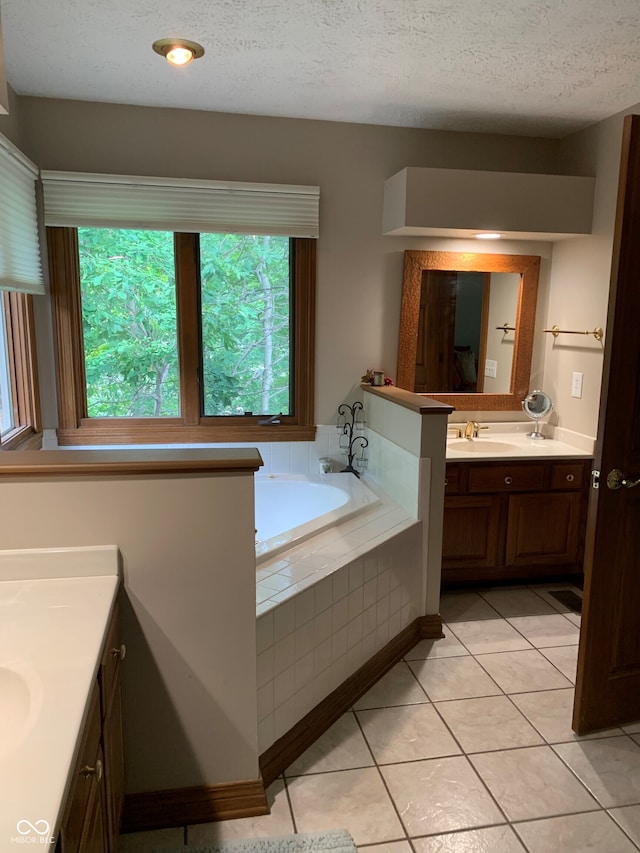 bathroom featuring vanity, tile patterned flooring, plenty of natural light, and a textured ceiling