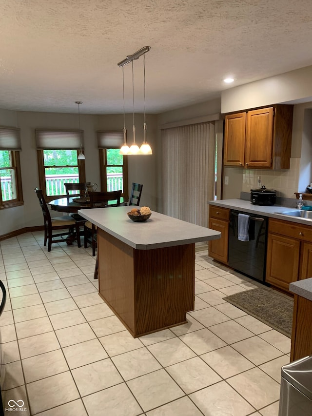 kitchen featuring hanging light fixtures, a textured ceiling, dishwasher, and a kitchen island