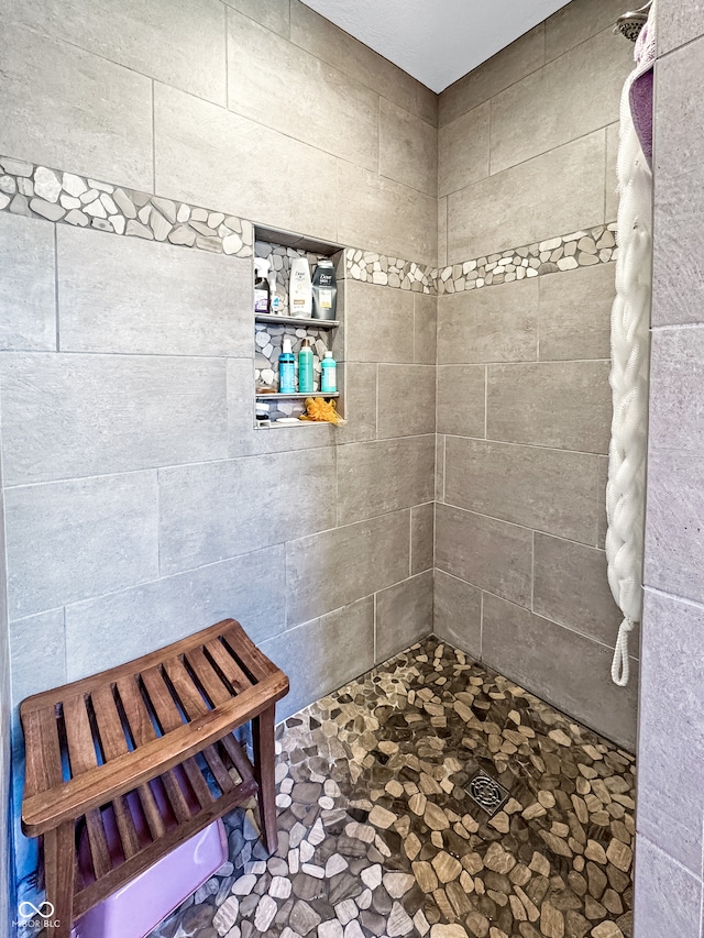 bathroom with tiled shower