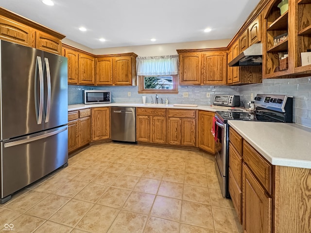 kitchen with extractor fan, decorative backsplash, sink, light tile patterned flooring, and stainless steel appliances