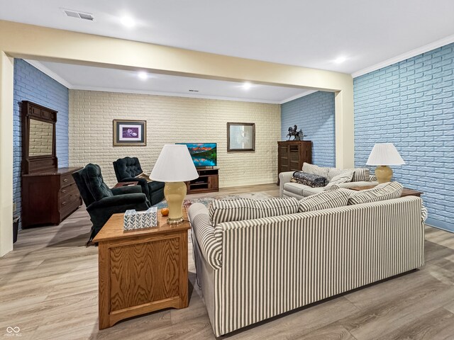 living room with brick wall and light wood-type flooring