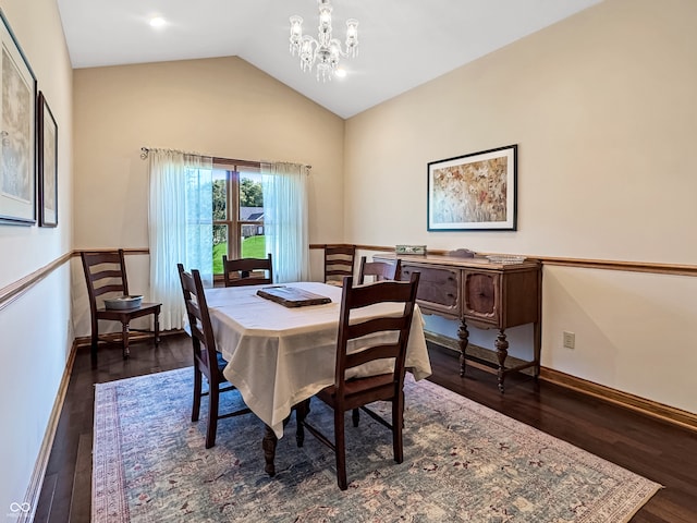 dining area with vaulted ceiling, dark hardwood / wood-style flooring, and an inviting chandelier