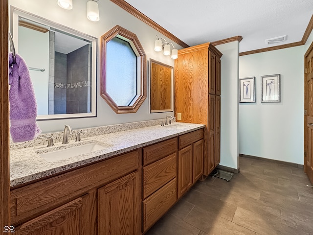 bathroom with vanity and ornamental molding