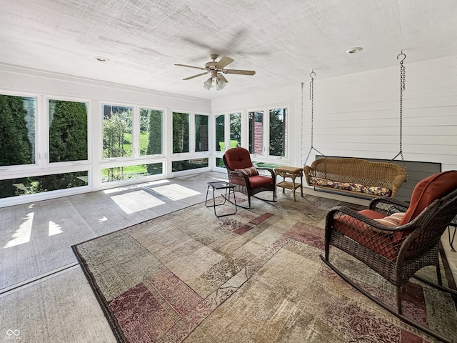 sunroom featuring ceiling fan and a healthy amount of sunlight