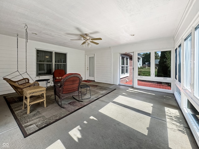 sunroom featuring ceiling fan