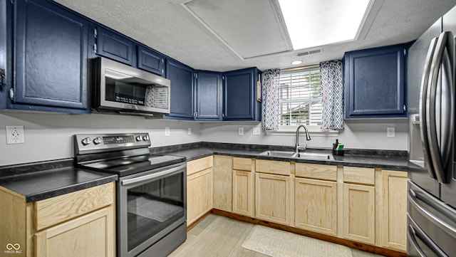 kitchen with light hardwood / wood-style floors, stainless steel appliances, sink, and blue cabinets