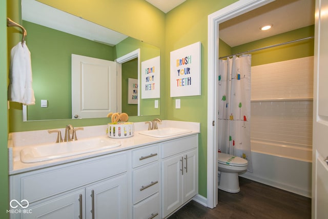 full bathroom with vanity, toilet, hardwood / wood-style floors, and shower / bath combo