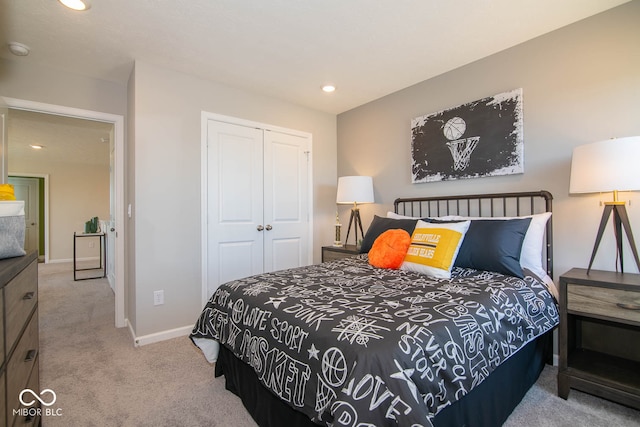 bedroom with light colored carpet and a closet