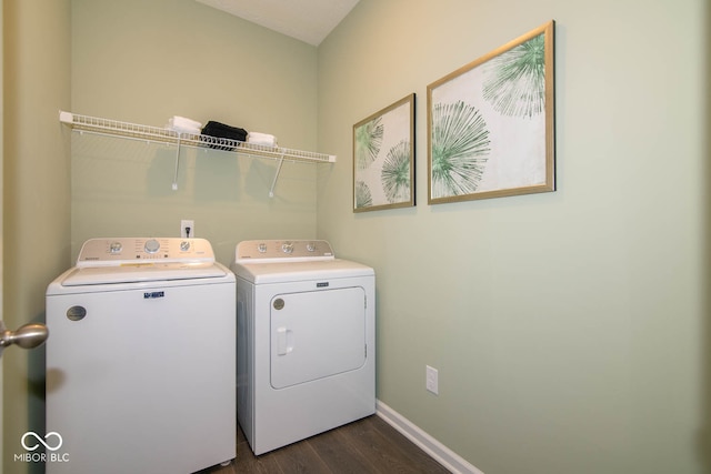 clothes washing area featuring washer and dryer and dark hardwood / wood-style floors