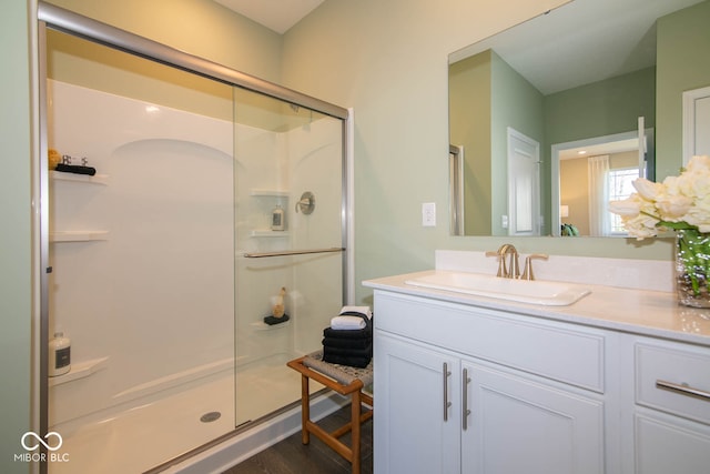 bathroom with vanity and a shower with shower door